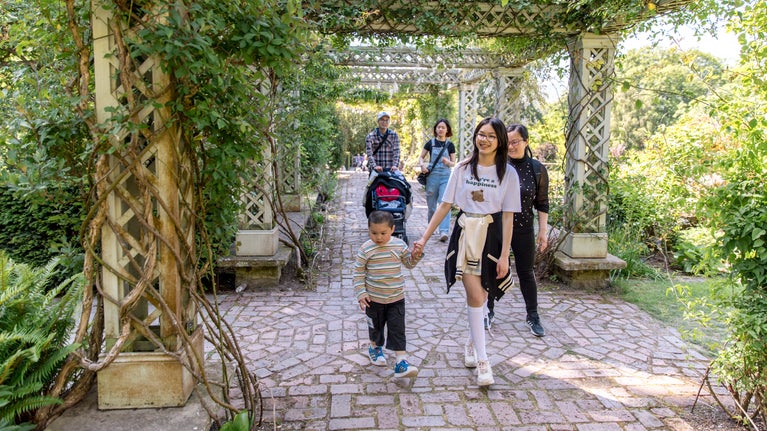 Visitors exploring the Formal garden at Bodnant Garden, Conwy, Wales